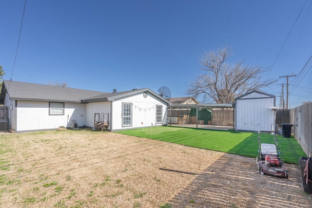 view of yard featuring a fenced backyard, cooling unit, an outdoor structure, and a shed