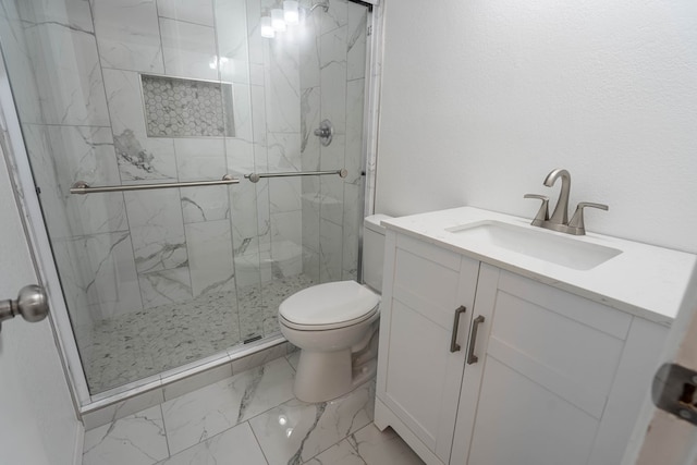 full bath featuring a marble finish shower, marble finish floor, toilet, and vanity