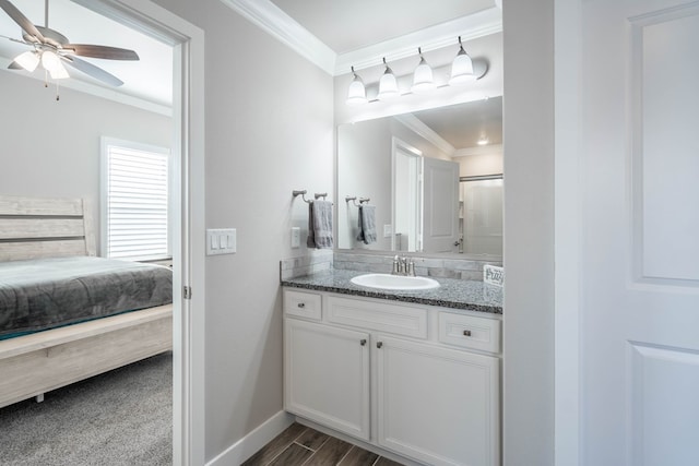 bathroom featuring vanity, ceiling fan, and crown molding