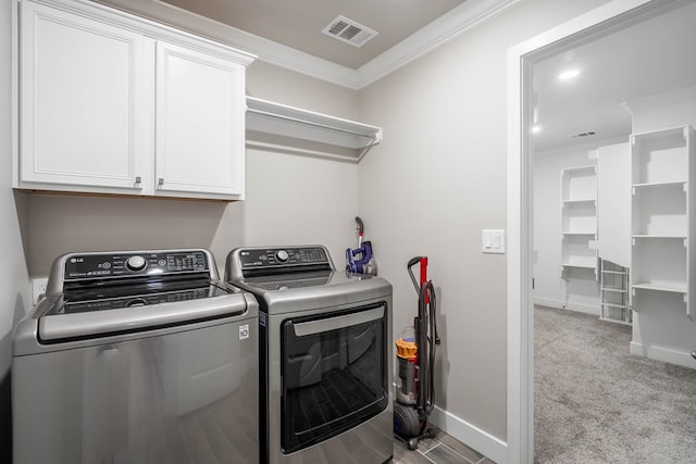 washroom with crown molding, cabinets, light carpet, and separate washer and dryer