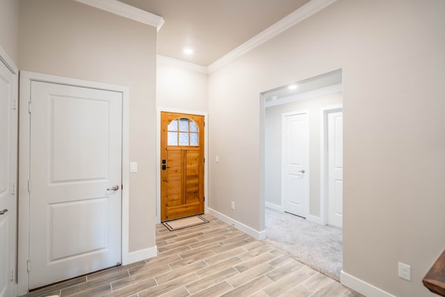 entrance foyer featuring light hardwood / wood-style flooring and ornamental molding