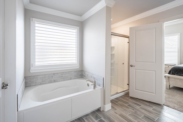 bathroom featuring ornamental molding and separate shower and tub