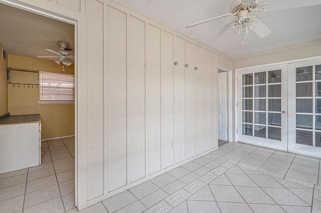 unfurnished sunroom featuring french doors and ceiling fan