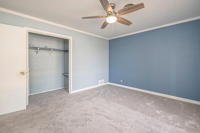 unfurnished bedroom featuring carpet floors, a closet, visible vents, and crown molding