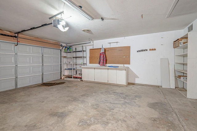 garage with visible vents and a garage door opener