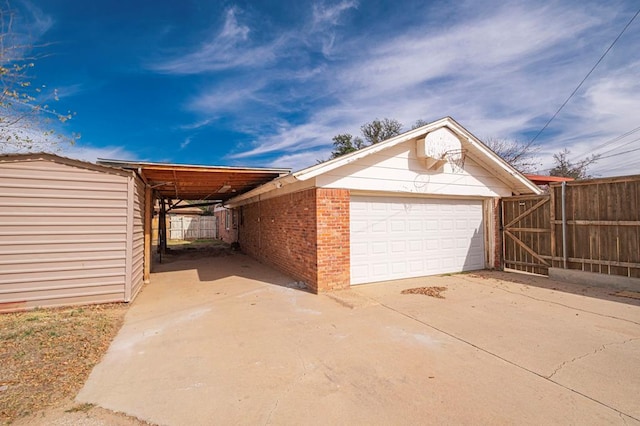 view of home's exterior with a gate, brick siding, and fence