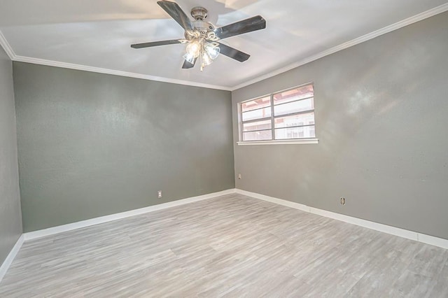 empty room featuring ceiling fan, ornamental molding, wood finished floors, and baseboards