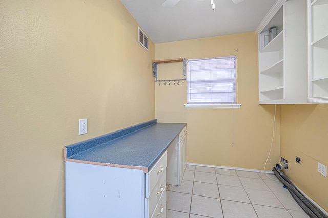 clothes washing area with light tile patterned floors and ceiling fan