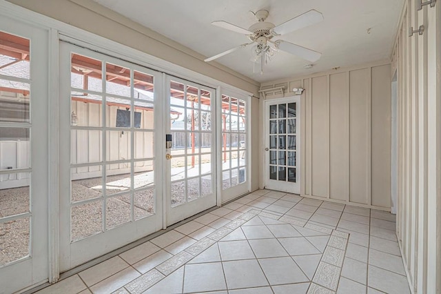 unfurnished sunroom featuring ceiling fan