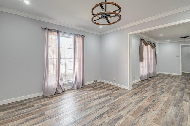 unfurnished room with crown molding, baseboards, and wood finished floors