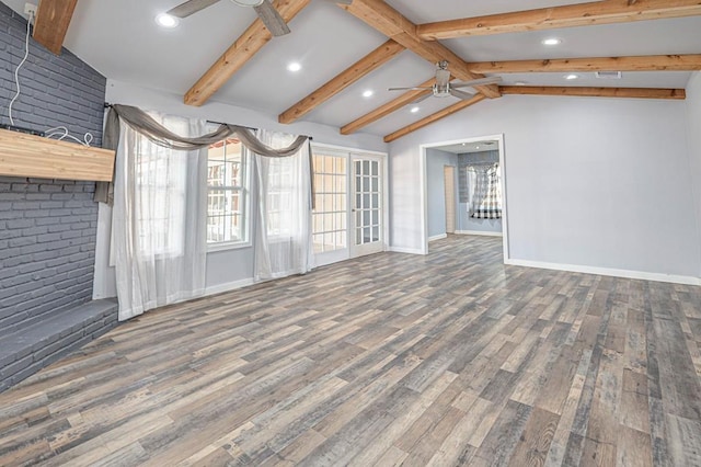 unfurnished living room with ceiling fan, wood finished floors, and vaulted ceiling with beams