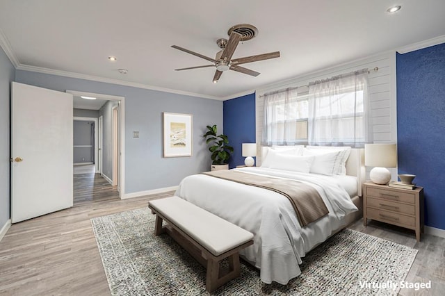 bedroom featuring ceiling fan, ornamental molding, and light wood-type flooring