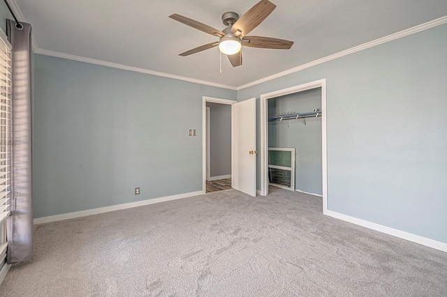 unfurnished bedroom featuring baseboards, ceiling fan, carpet, crown molding, and a closet