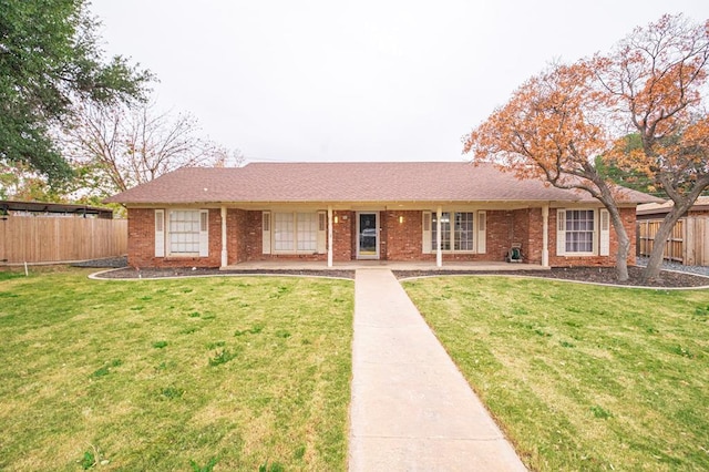 single story home with brick siding, a front lawn, and fence