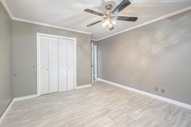 unfurnished bedroom with crown molding, light hardwood / wood-style flooring, and a closet