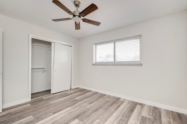 unfurnished bedroom with baseboards, ceiling fan, a closet, and light wood finished floors