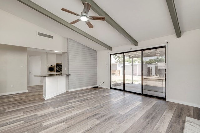 unfurnished living room featuring beam ceiling, light wood finished floors, a ceiling fan, baseboards, and visible vents