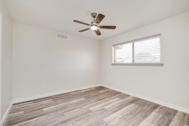 empty room with visible vents, baseboards, ceiling fan, and wood finished floors