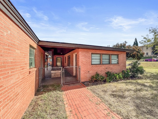 entrance to property with a lawn