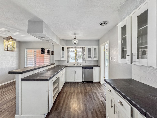 kitchen featuring white cabinetry, dishwasher, decorative light fixtures, and kitchen peninsula