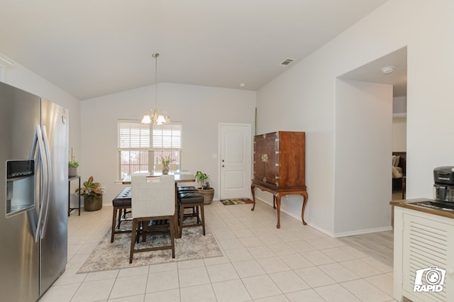 dining room featuring lofted ceiling, light tile patterned floors, a chandelier, visible vents, and baseboards