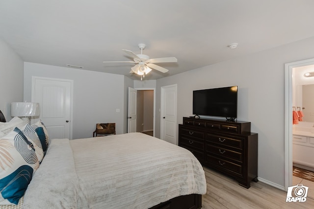 bedroom featuring light wood finished floors, visible vents, ensuite bathroom, a ceiling fan, and baseboards