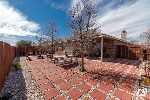 view of patio with a fenced backyard and a fire pit