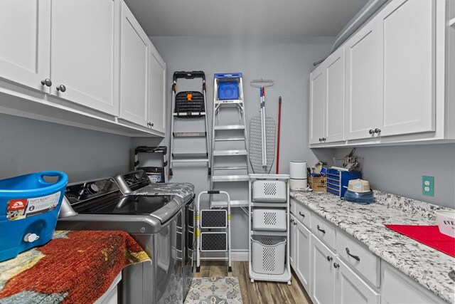 6811 Elkins Rd, Midland, TX 79705 - laundry room featuring independent washer and dryer, cabinet space, and light wood-style floors