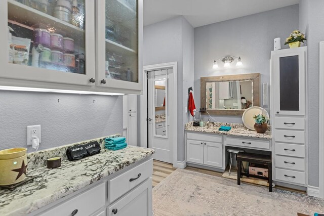 6811 Elkins Rd, Midland, TX 79705 - bathroom with vanity and wood finished floors