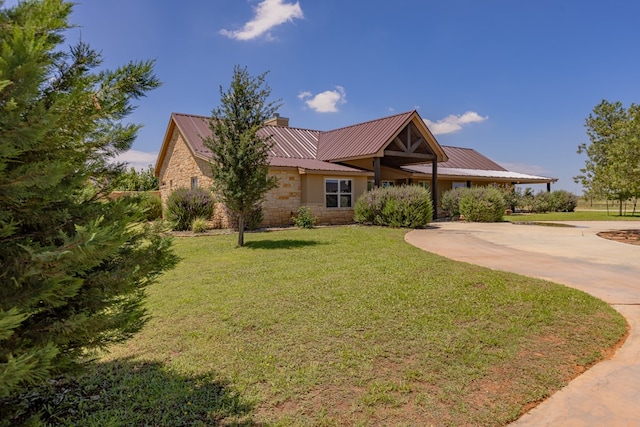 6811 Elkins Rd, Midland, TX 79705 - ranch-style house with stone siding, a metal roof, a chimney, and a front lawn