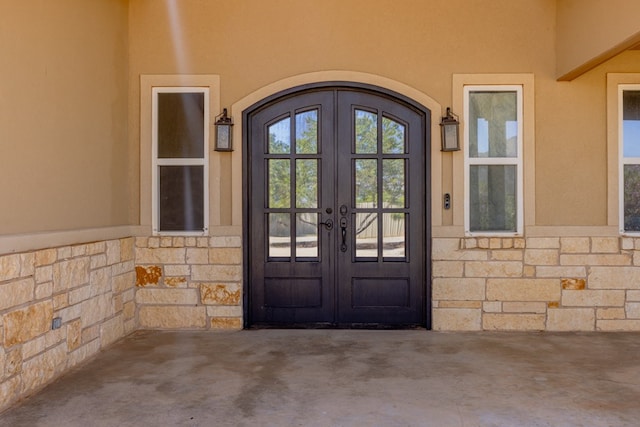 6811 Elkins Rd, Midland, TX 79705 - doorway to property with french doors, stone siding, and stucco siding