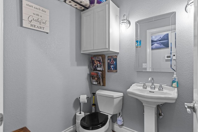 6811 Elkins Rd, Midland, TX 79705 - half bathroom with toilet and baseboards