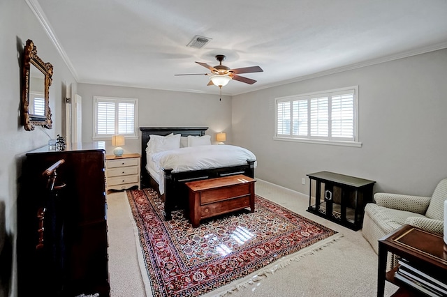 carpeted bedroom featuring ornamental molding and ceiling fan