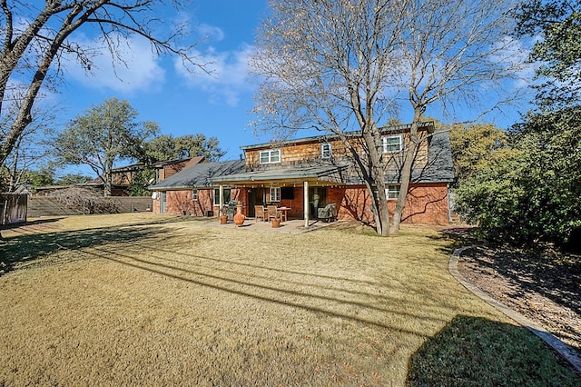 back of house with a patio and a yard