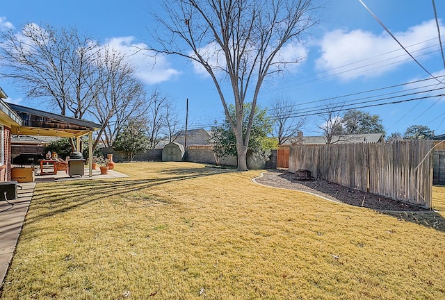 view of yard with a gazebo, a shed, and a patio