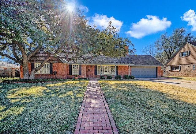 view of front of house with a garage and a front yard