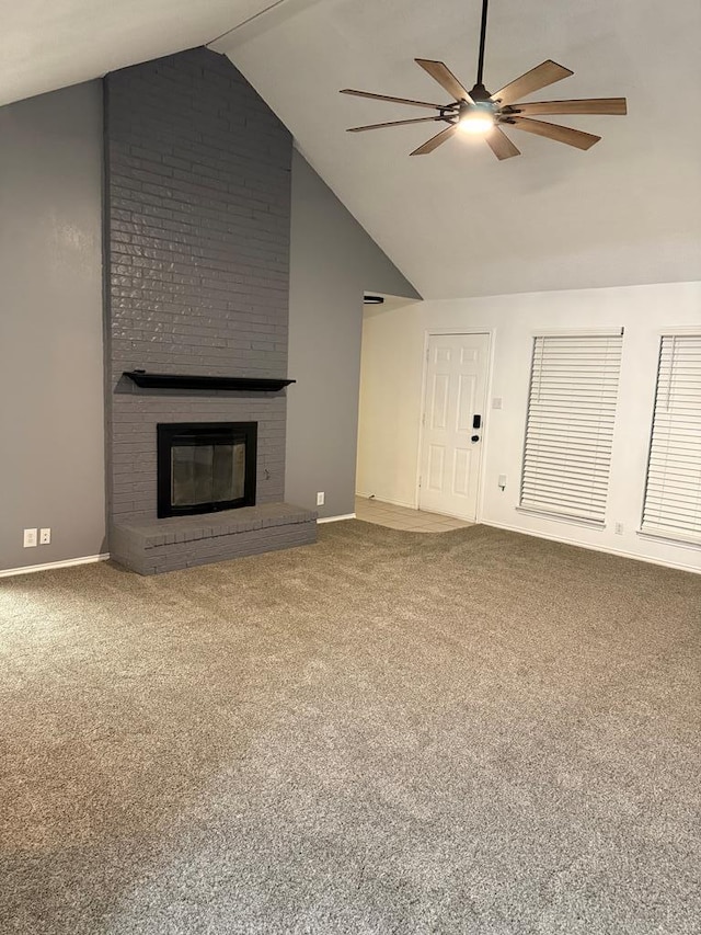 unfurnished living room with high vaulted ceiling, carpet, ceiling fan, and a fireplace