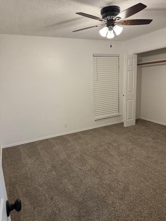 unfurnished bedroom featuring baseboards, ceiling fan, carpet floors, a closet, and a textured ceiling