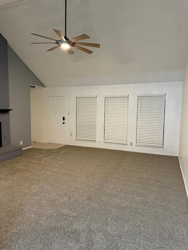 unfurnished living room with high vaulted ceiling, carpet floors, a fireplace, baseboards, and ceiling fan