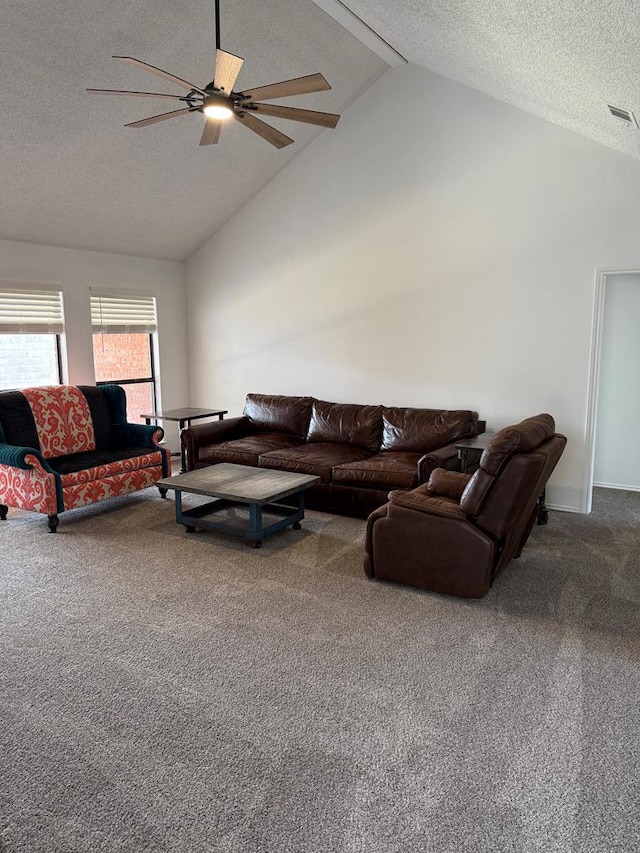 carpeted living room featuring a textured ceiling, a ceiling fan, visible vents, and high vaulted ceiling