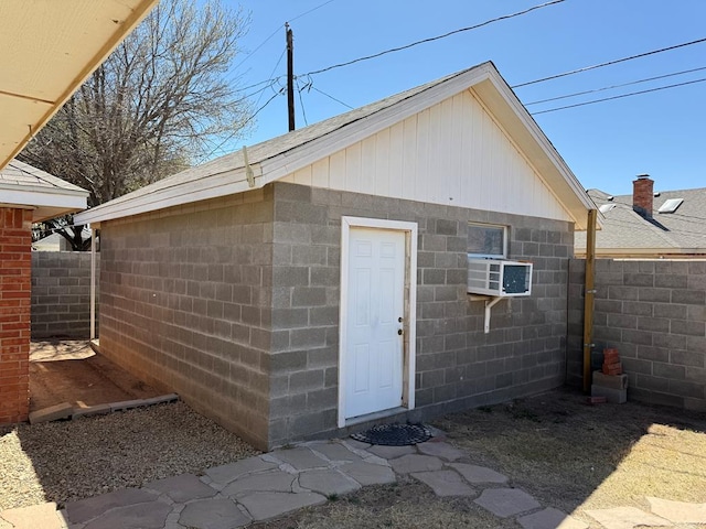 view of outbuilding featuring an outdoor structure and fence