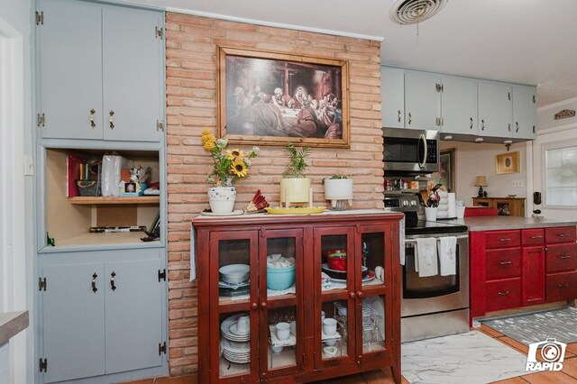 kitchen featuring visible vents, stainless steel appliances, and light countertops