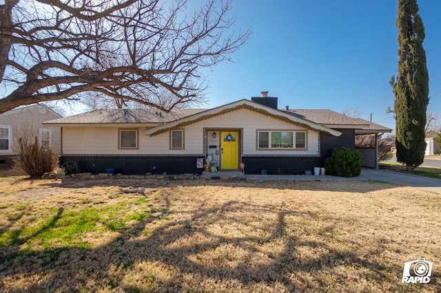 single story home featuring an attached carport, brick siding, driveway, and a chimney