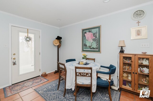 dining room with ornamental molding and tile patterned floors