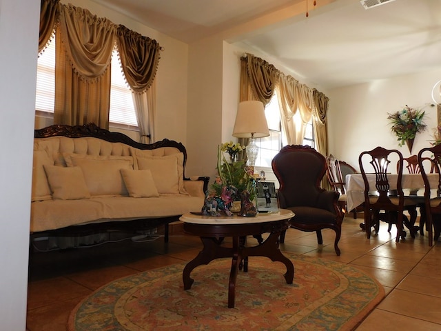 living area with tile patterned flooring and visible vents