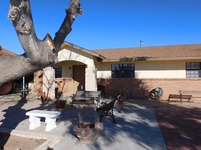 exterior space featuring an outdoor fire pit