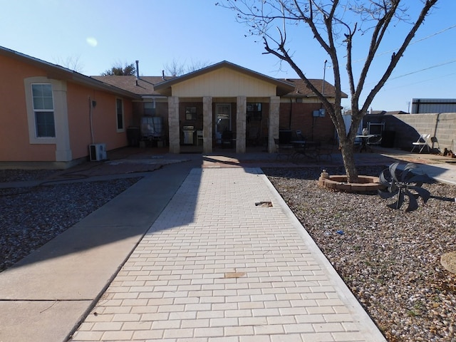 ranch-style house featuring a patio area and fence