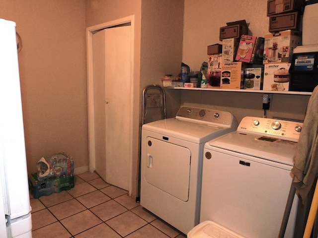 washroom with independent washer and dryer and light tile patterned floors