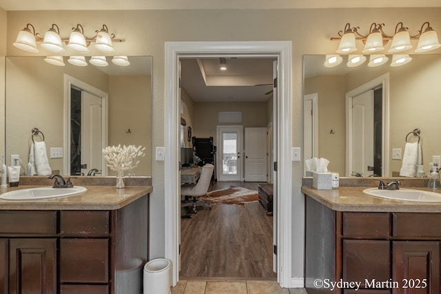 full bathroom featuring ensuite bathroom, two vanities, and tile patterned flooring