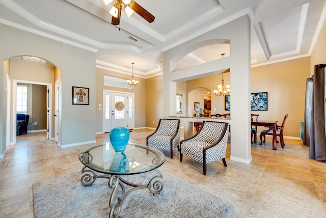 living area featuring baseboards, arched walkways, visible vents, and crown molding